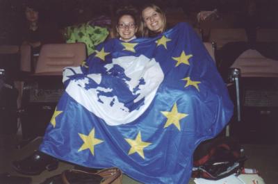 17: The plenary was cold - CD members Aniko Vass and Makin Kaiser took shelter under an AEGEE flag.