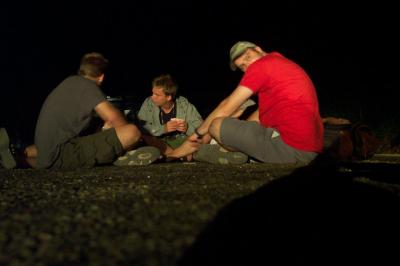 42: card playing in the middle of the road at night