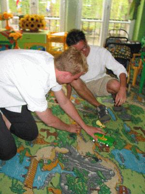 12: Bram and Michiel couldn't resist the temptation to play with the cars on a huge playingcarpet :)