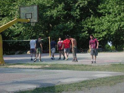 87: Serhan and Alfredo playing basketball along with some Greek people.